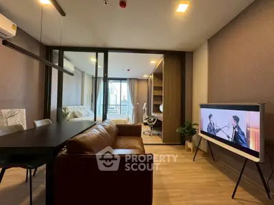 Modern living room with open layout, stylish furniture, and city view balcony in luxury apartment.