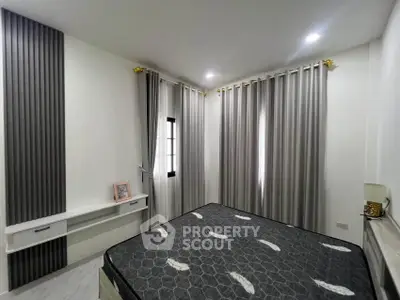 Modern bedroom with stylish curtains and elegant decor in a contemporary home.