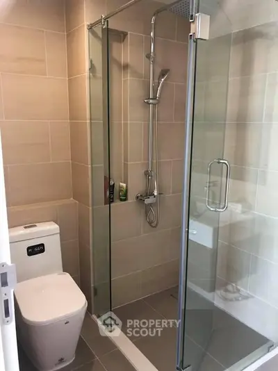 Modern bathroom with glass shower enclosure and sleek fixtures