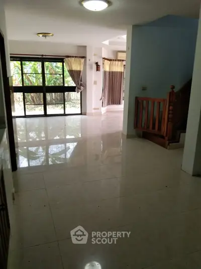 Spacious open-plan living area with large windows and natural light.