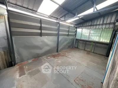 Spacious industrial-style storage unit with metal walls and roof, ideal for versatile use.