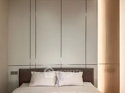 Modern bedroom with sleek paneling and cozy bed setup