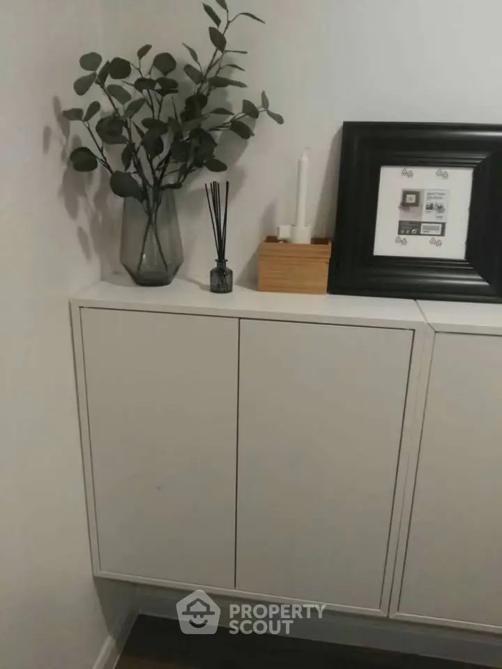Stylish modern interior with sleek white cabinet and decorative elements.