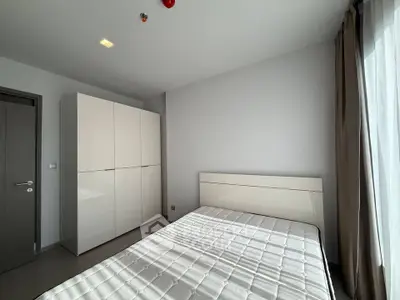 Modern bedroom with sleek wardrobe and natural light