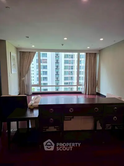 Spacious living room with large windows and city view in modern apartment