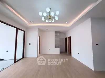 Spacious modern living room with elegant lighting and wooden flooring