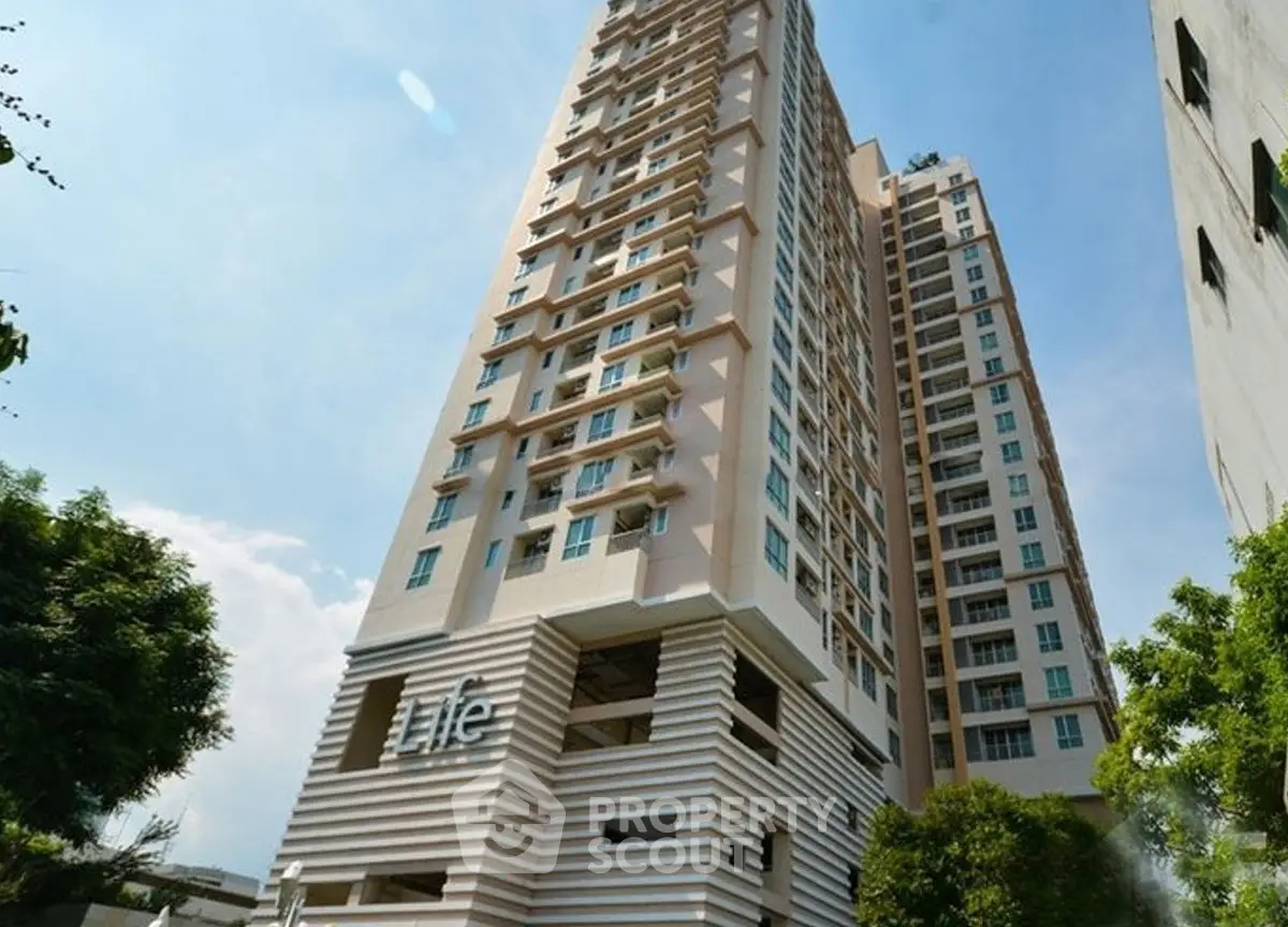Modern high-rise residential building with sleek design and urban appeal.