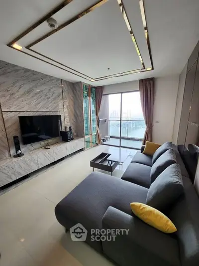 Luxurious living room with modern decor and stunning city view from balcony.