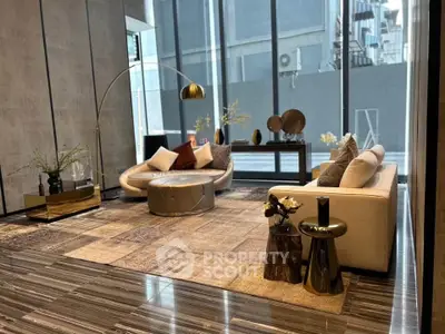 Luxurious modern living room with stylish furniture and large windows offering city views.