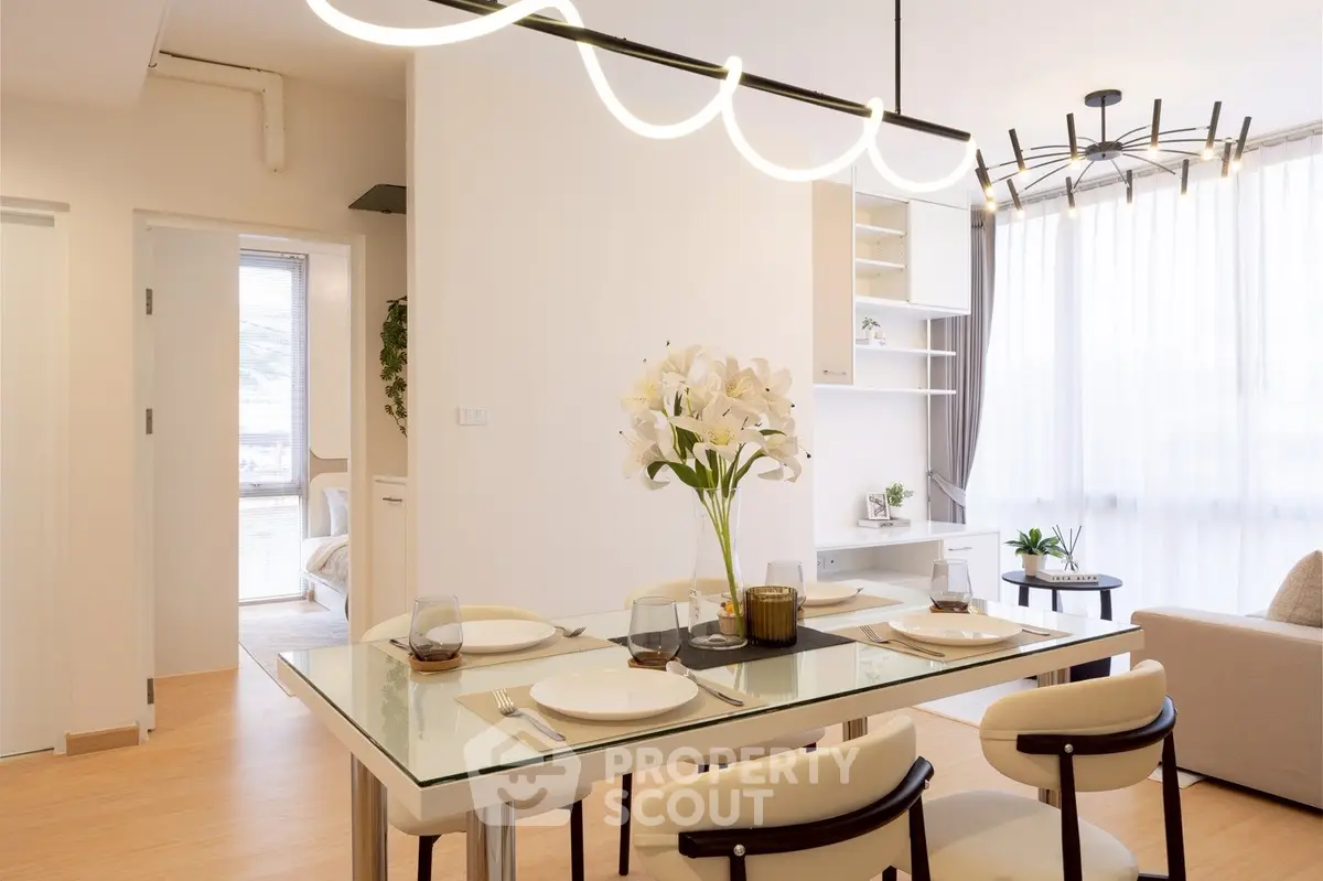 Modern dining area with elegant lighting and stylish decor in a bright open-plan living space.