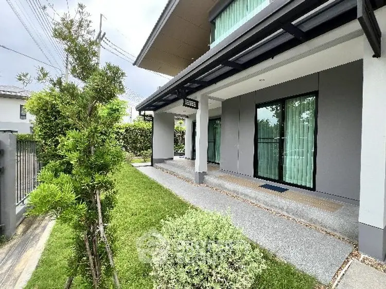 Modern house exterior with lush garden and sleek design