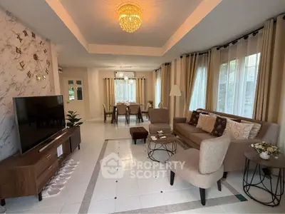 Elegant living room with modern decor, featuring a stylish chandelier and spacious seating area.