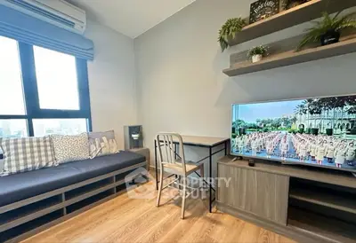 Modern living room with stylish decor, large window, and cozy seating area.