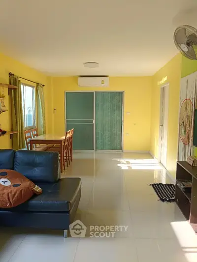 Bright living room with modern furniture and large windows in a stylish apartment.