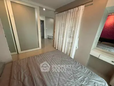 Cozy bedroom with sliding closet doors and elegant curtains in modern apartment.