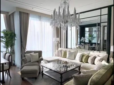 Luxurious living room with elegant chandelier and plush seating in modern apartment