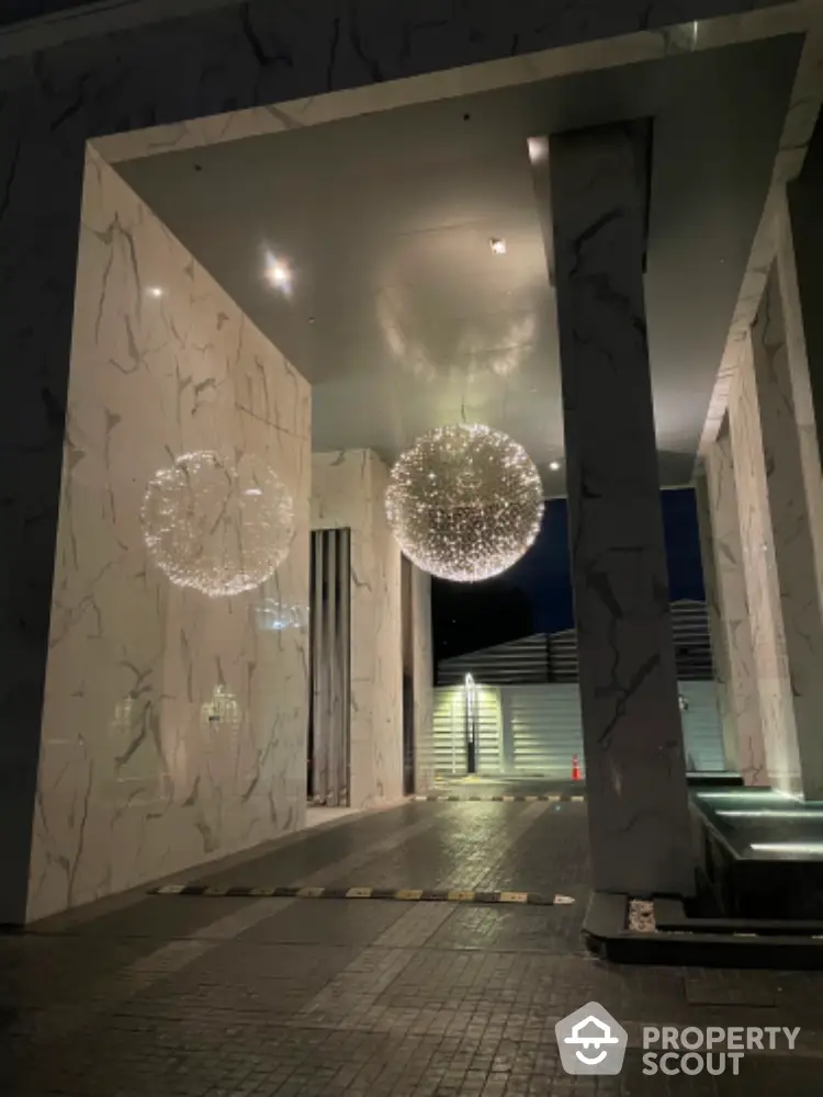 Luxurious modern building entrance with elegant lighting and marble design