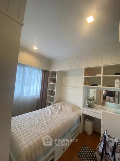 Cozy bedroom with built-in storage and natural light