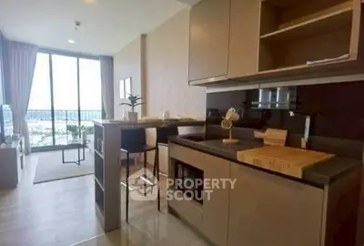 Modern open-layout kitchen and living room with large windows and city view.