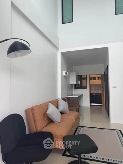 Modern living room with high ceiling and stylish furniture in a contemporary apartment.