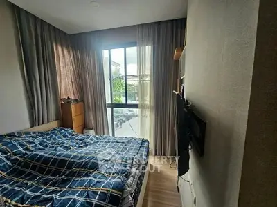Cozy bedroom with large window and modern decor in a stylish apartment.