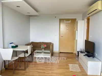 Modern living room with sleek furniture and wooden flooring in a cozy apartment.