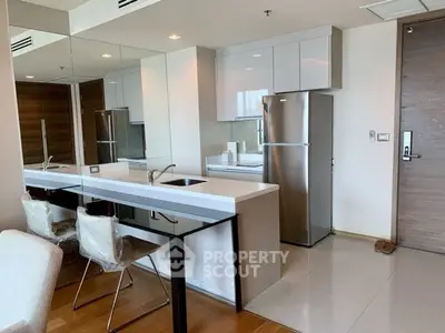 Modern kitchen with sleek appliances and open layout in contemporary apartment.