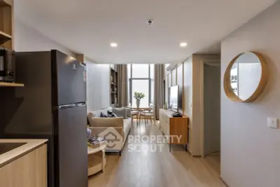 Modern living room with open layout and stylish furniture in a high-rise apartment.