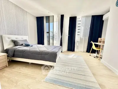 Modern bedroom with city view, featuring stylish decor and ample natural light.