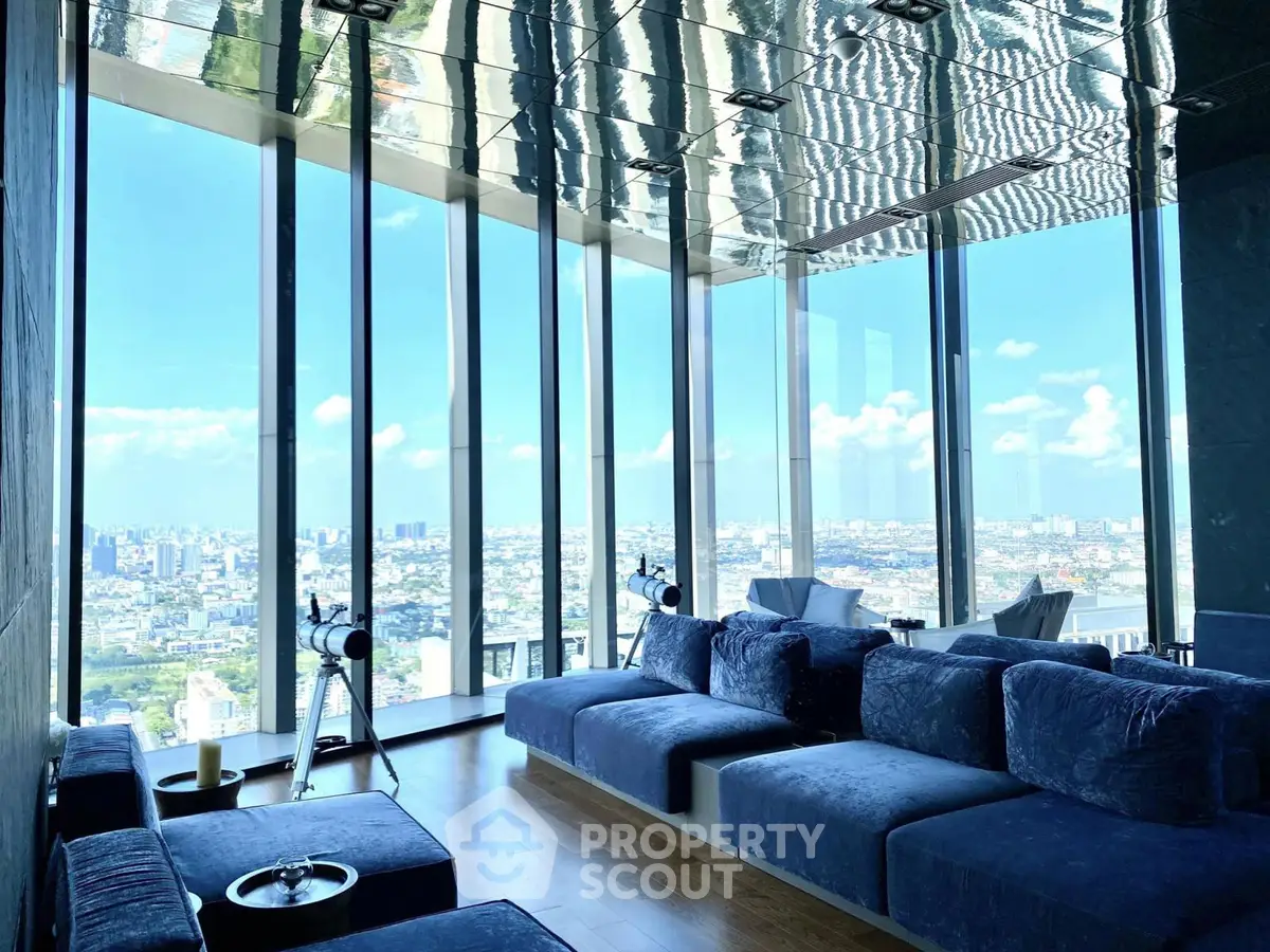 Luxurious living room with panoramic city views and modern blue sofas