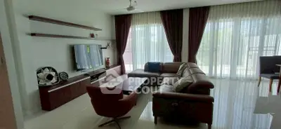 Spacious living room with modern furniture and large windows for natural light.