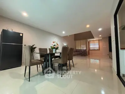 Spacious modern dining area with elegant decor and open layout, perfect for entertaining guests.