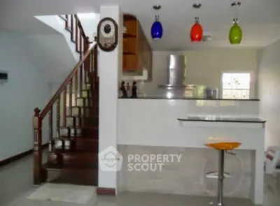 Modern kitchen with colorful pendant lights and sleek breakfast bar
