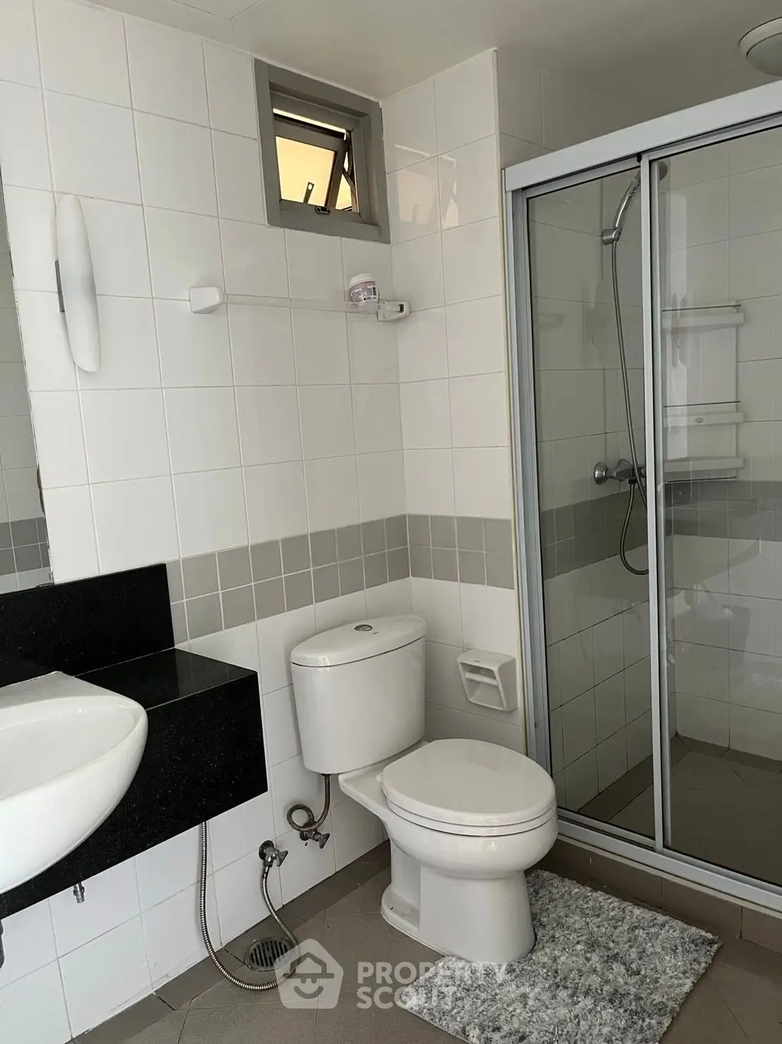 Modern bathroom with glass shower and sleek fixtures in a contemporary home.