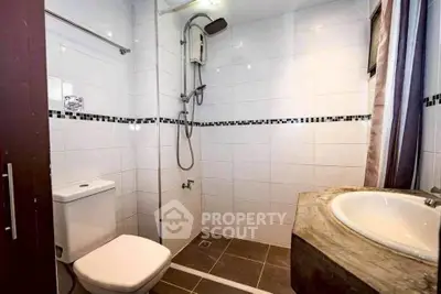 Modern bathroom with sleek shower and stylish sink in a contemporary home.