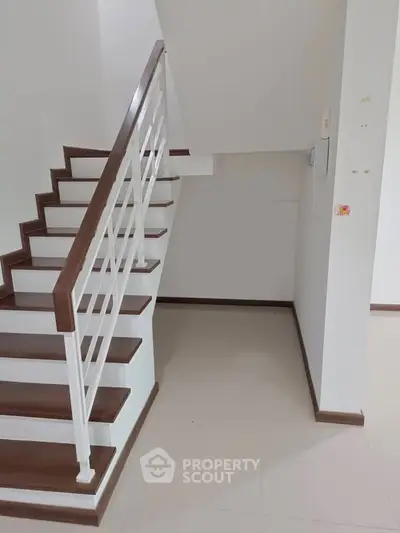 Modern staircase with wooden handrails in a minimalist interior design
