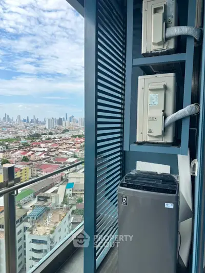 Stunning city view from high-rise balcony with modern appliances and sleek design.