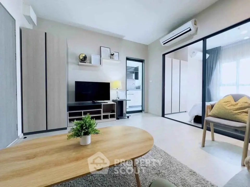 Modern living room with sleek furniture and open layout in a stylish apartment.