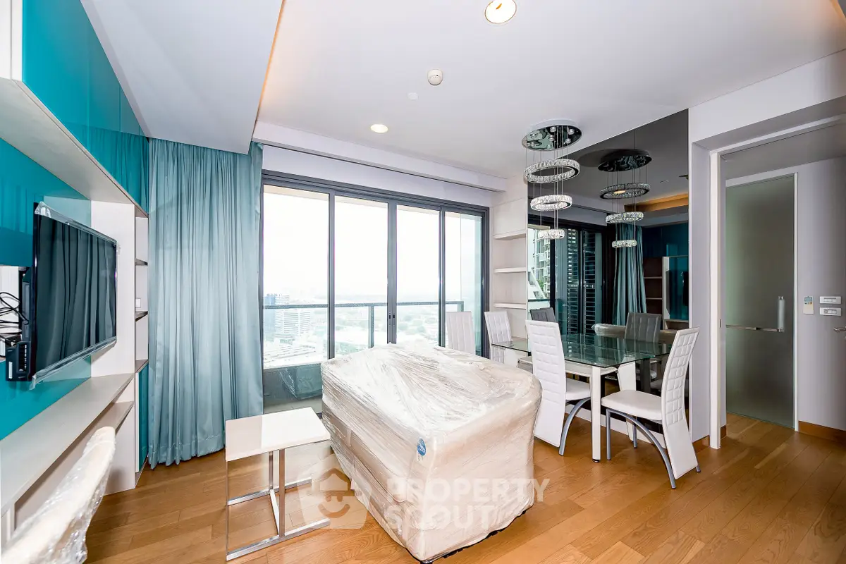 Modern living room with panoramic city view and stylish dining area