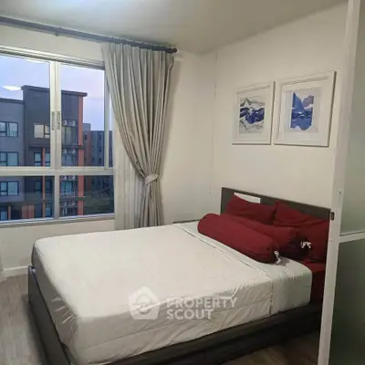 Cozy bedroom with modern decor and large window offering city view