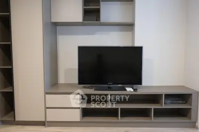 Modern living room with sleek TV unit and ample storage space