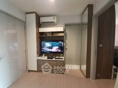 Modern living room with built-in TV unit and air conditioning in stylish apartment.