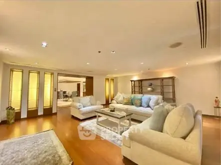 Spacious and elegant living room with modern decor and cozy seating area.
