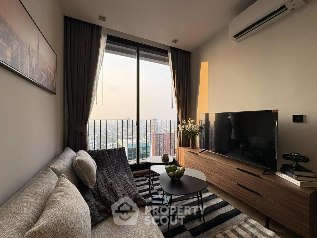 Modern living room with city view, cozy sofa, and stylish decor.