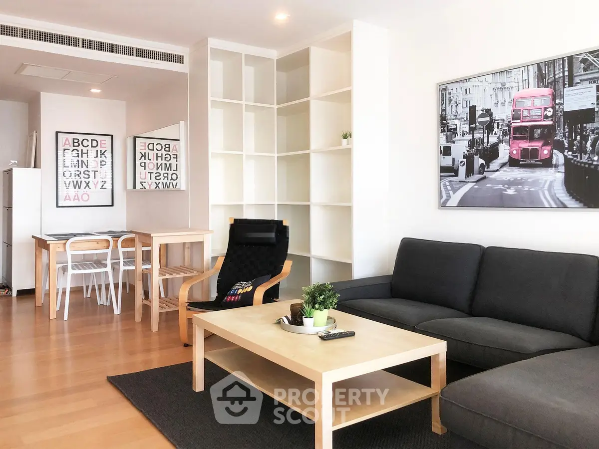 Modern living room with stylish furniture and open layout, featuring a cozy seating area and dining space.
