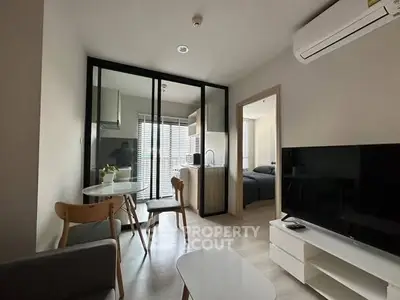 Modern apartment interior with open layout, featuring a cozy living area and stylish kitchen.