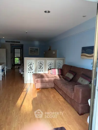 Spacious living room with elegant decor and natural light in modern apartment.