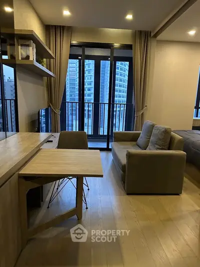 Modern living room with stylish furniture and city view balcony in a high-rise apartment.