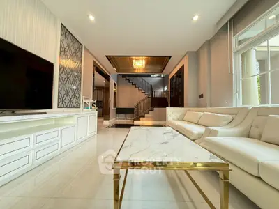 Luxurious living room with elegant decor and modern staircase in a spacious home