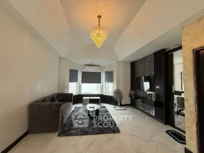 Luxurious living room with modern decor and elegant chandelier